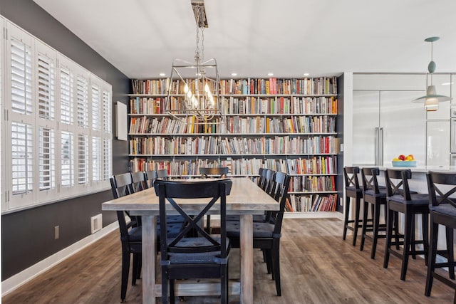 dining room featuring an inviting chandelier and wood-type flooring