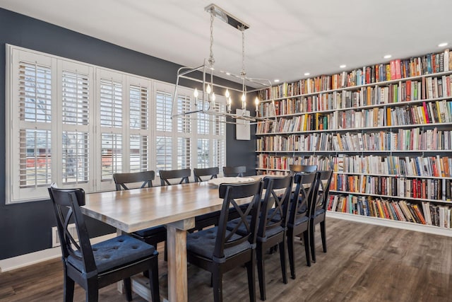 dining area featuring dark hardwood / wood-style flooring and a chandelier