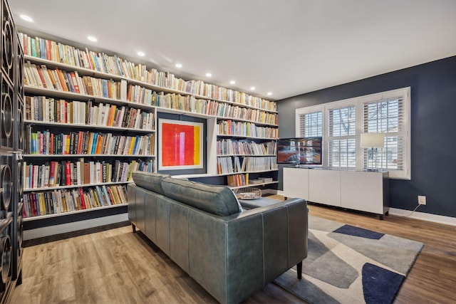 sitting room with radiator heating unit and light wood-type flooring