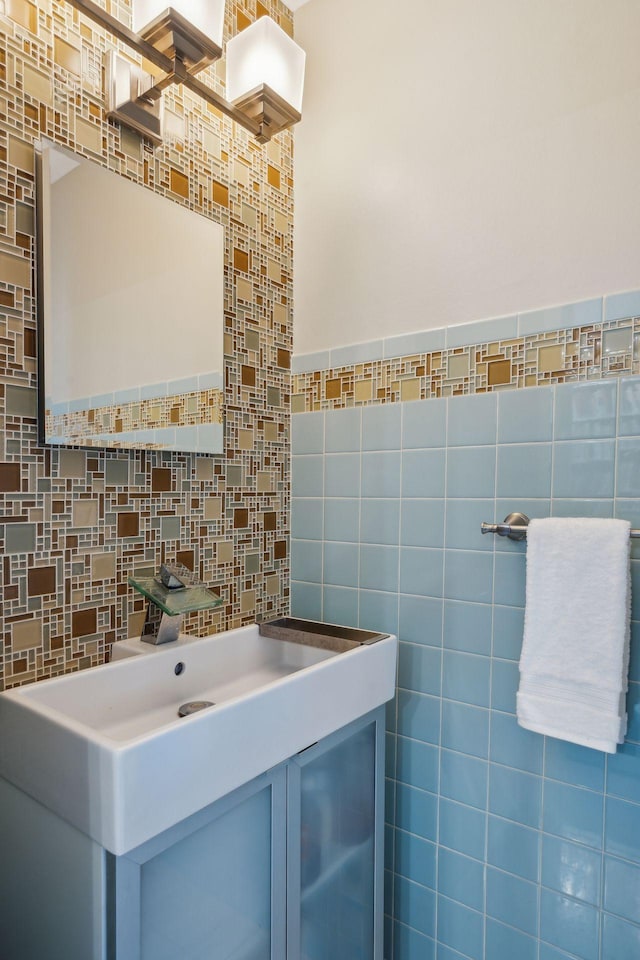 bathroom featuring vanity and tile walls