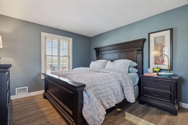 bedroom with dark hardwood / wood-style floors