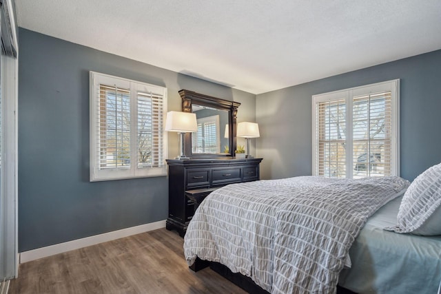 bedroom featuring wood-type flooring and a textured ceiling