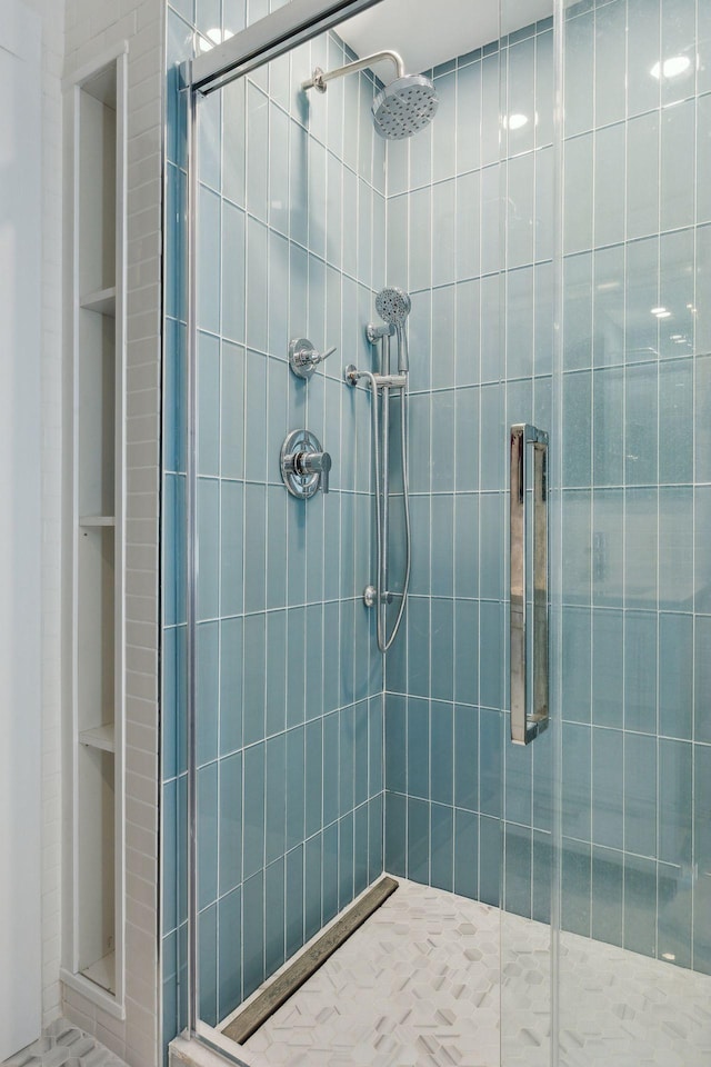 bathroom featuring a shower with door