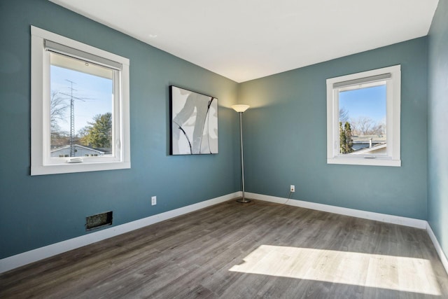 spare room featuring hardwood / wood-style flooring and a wealth of natural light