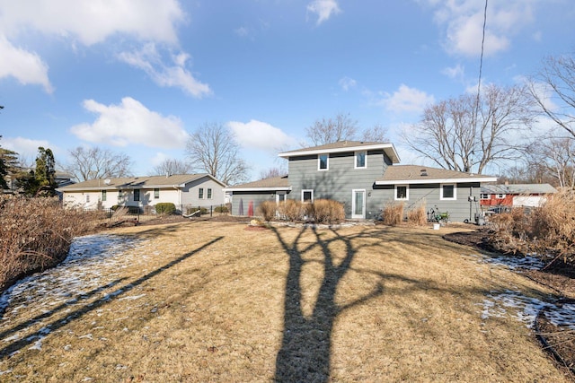 back of property featuring a lawn