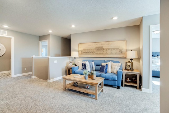 living room featuring light carpet and a textured ceiling