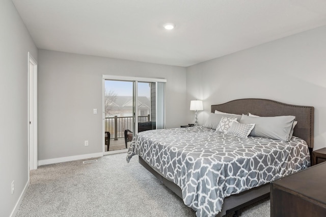 bedroom with carpet flooring and access to outside