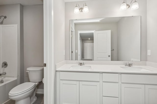 full bathroom with a notable chandelier, shower / bathtub combination, toilet, and vanity