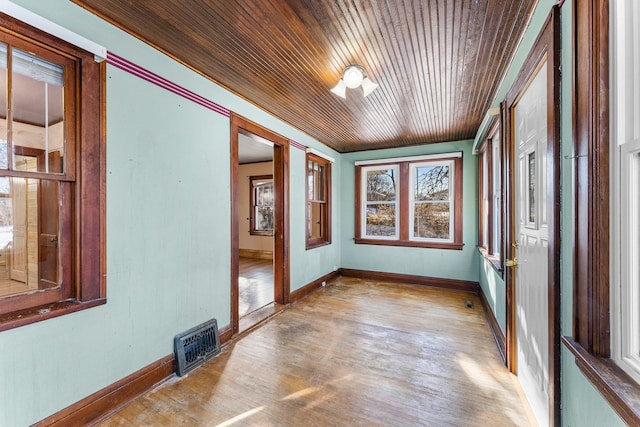 unfurnished sunroom featuring wooden ceiling