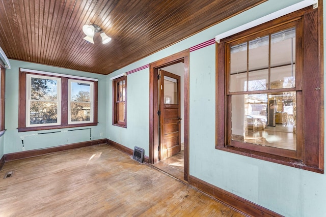 interior space with wooden ceiling, a wealth of natural light, and light hardwood / wood-style flooring