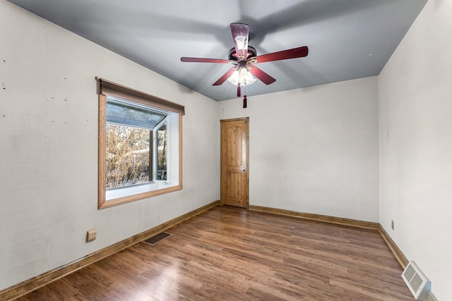 spare room with hardwood / wood-style flooring and ceiling fan