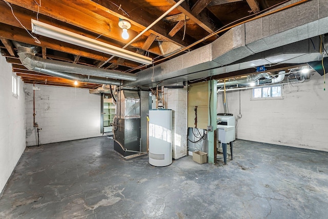 basement featuring sink, water heater, and heating unit