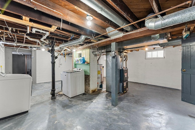 basement with separate washer and dryer, heating unit, and gas water heater