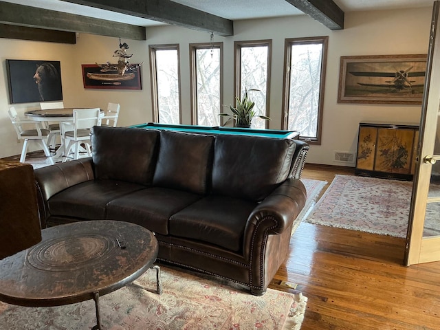 living room with hardwood / wood-style floors, beamed ceiling, and billiards