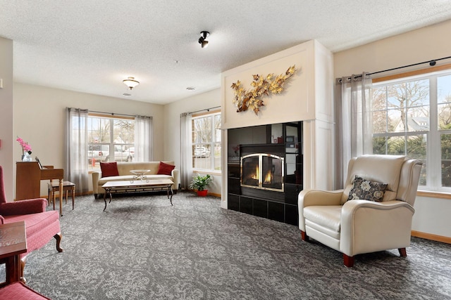 carpeted living room with a fireplace and a textured ceiling