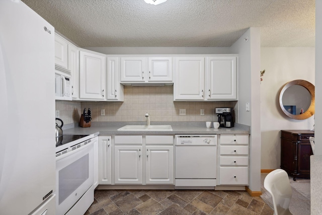 kitchen with tasteful backsplash, sink, white cabinets, white appliances, and a textured ceiling