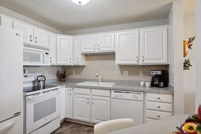 kitchen featuring sink, white cabinets, white appliances, and decorative backsplash