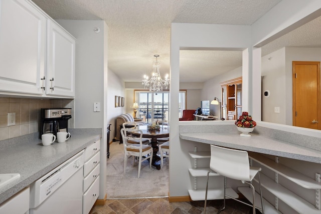 dining space featuring a textured ceiling and an inviting chandelier