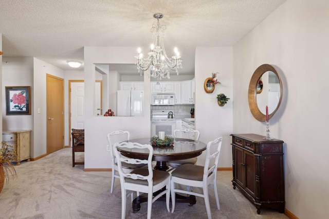 carpeted dining area featuring a textured ceiling and a notable chandelier