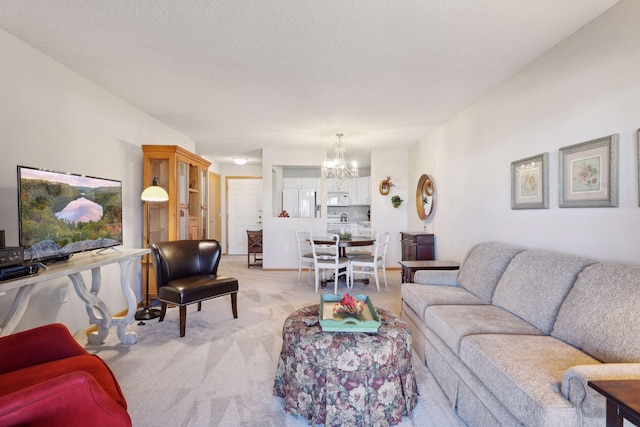 living room featuring light carpet, a textured ceiling, and a chandelier