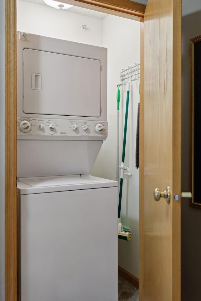 laundry area featuring stacked washer / drying machine