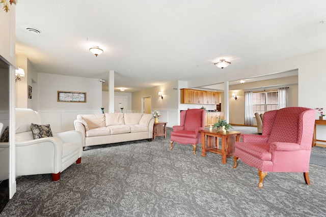 living room with dark colored carpet