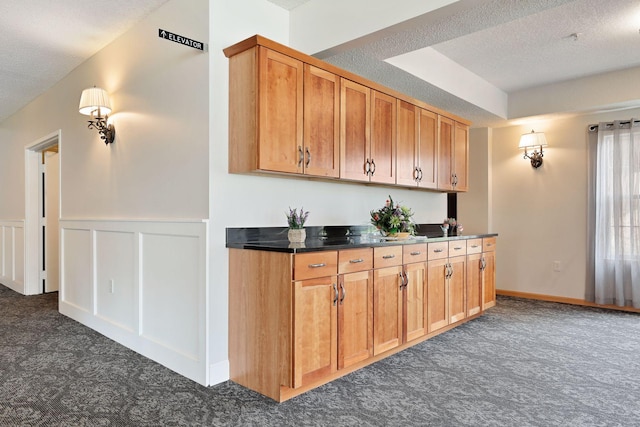 kitchen with a raised ceiling and a textured ceiling