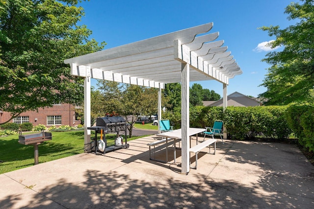 view of patio with area for grilling and a pergola