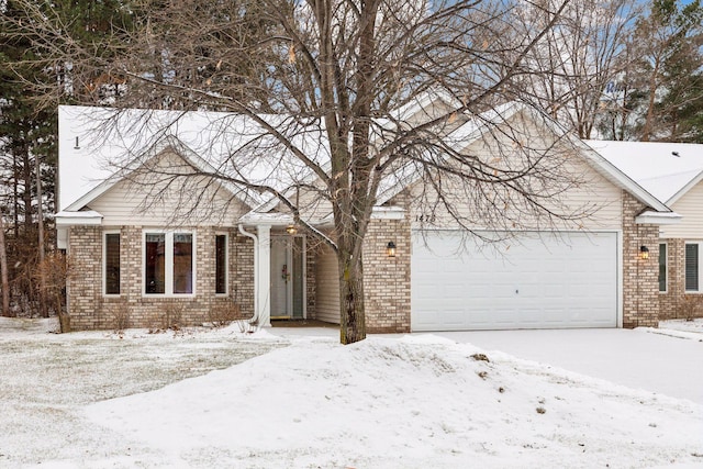 view of front of house with an attached garage and brick siding