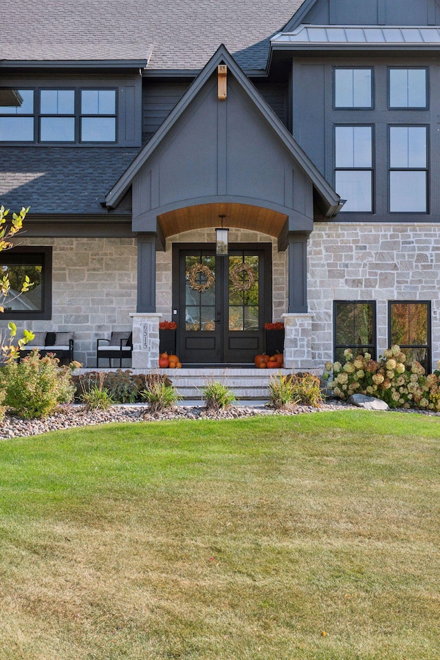 property entrance featuring a yard and french doors