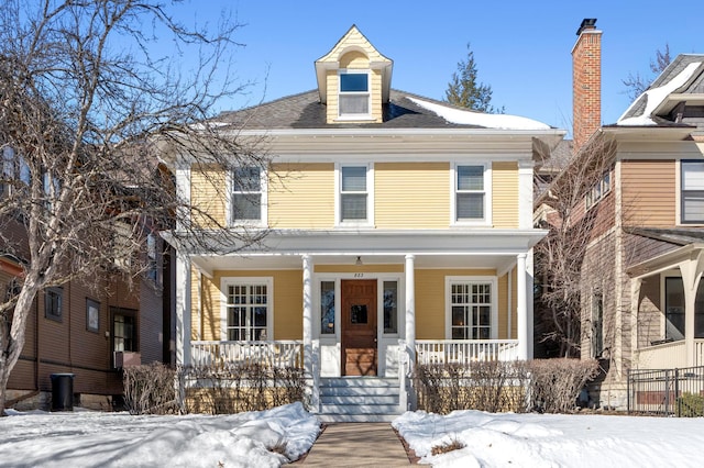 traditional style home featuring covered porch