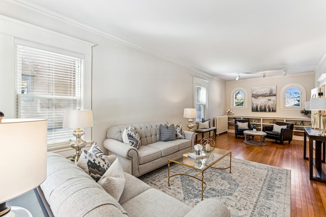 living room with crown molding and hardwood / wood-style floors