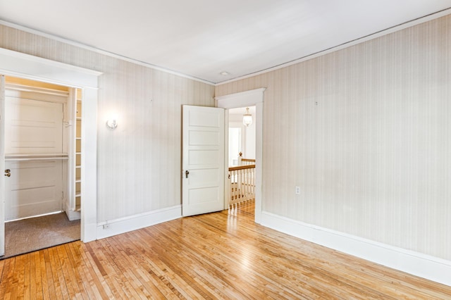 unfurnished bedroom featuring baseboards and wood-type flooring