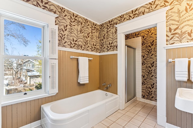 bathroom with wainscoting, a stall shower, and wallpapered walls