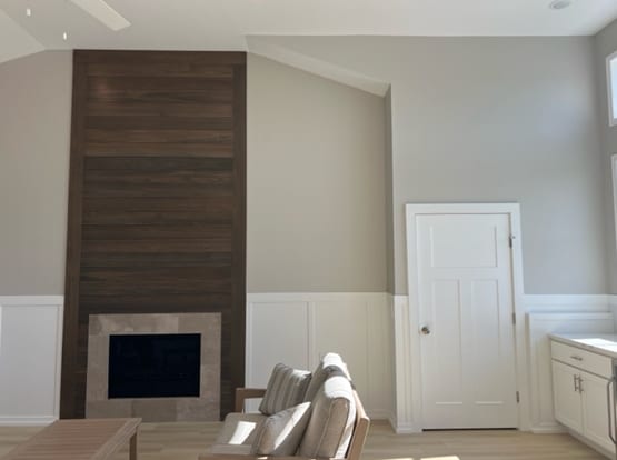 interior space featuring ceiling fan, a tile fireplace, and light hardwood / wood-style flooring