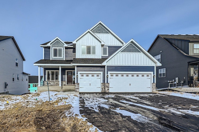 craftsman-style home featuring covered porch and a garage