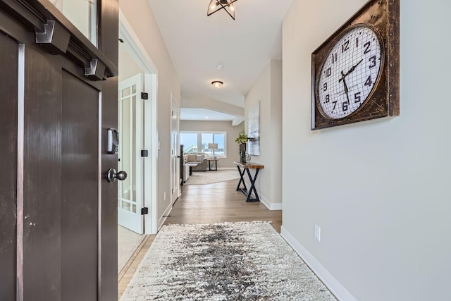 hallway with light hardwood / wood-style flooring