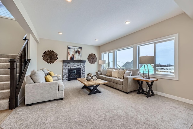 living room featuring carpet and a fireplace