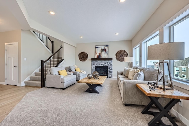 living room with light hardwood / wood-style floors and a fireplace