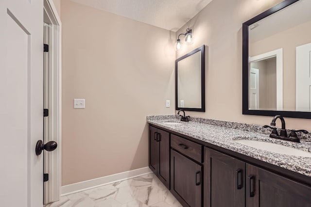 bathroom featuring a textured ceiling and vanity