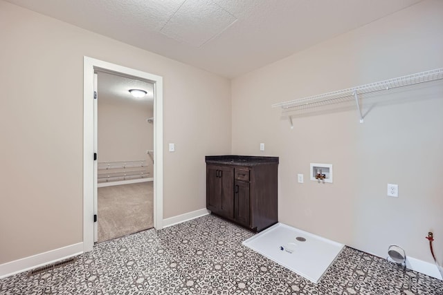 laundry room with hookup for a washing machine and a textured ceiling