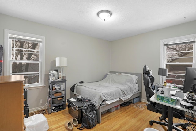 bedroom featuring a textured ceiling and hardwood / wood-style flooring