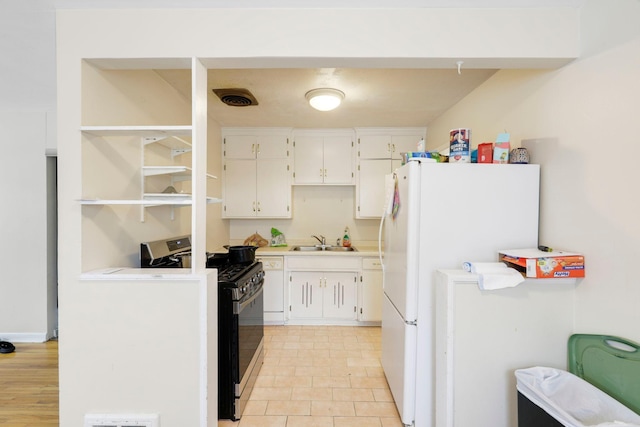 kitchen featuring white cabinetry, sink, and white appliances