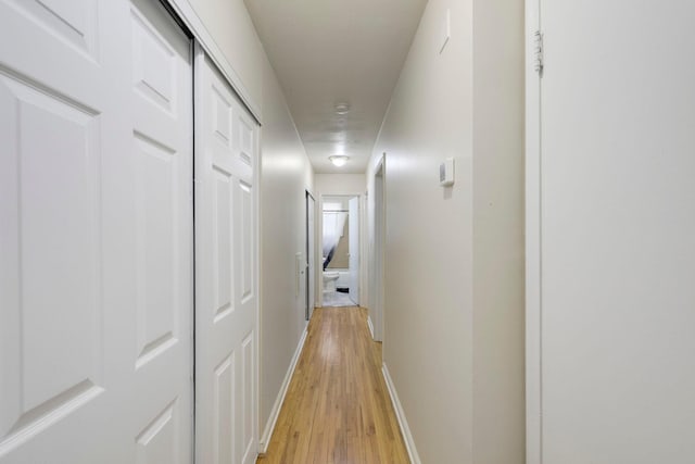 corridor with light hardwood / wood-style flooring