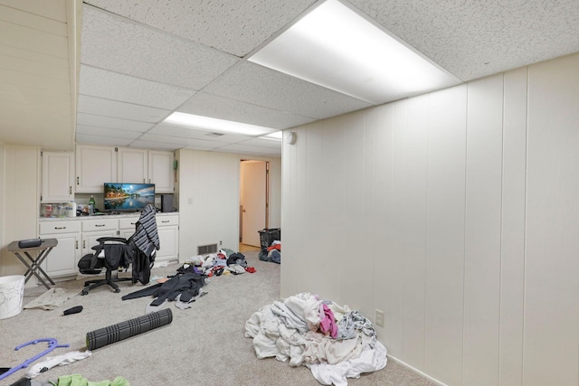 workout room with carpet and a drop ceiling