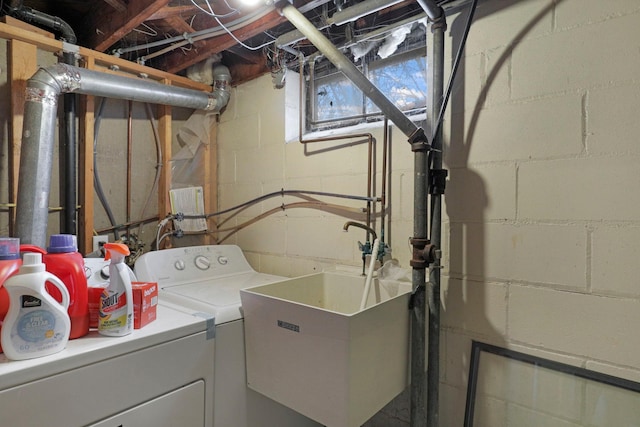 laundry room with separate washer and dryer and sink