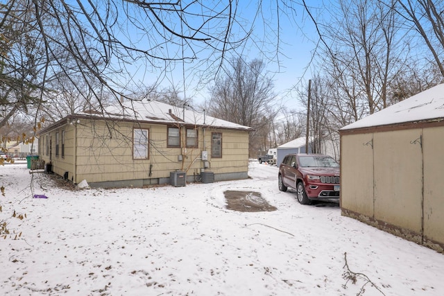 view of snow covered exterior featuring central AC unit