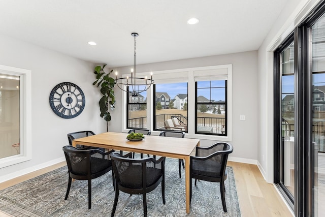 dining room featuring light hardwood / wood-style flooring and a notable chandelier