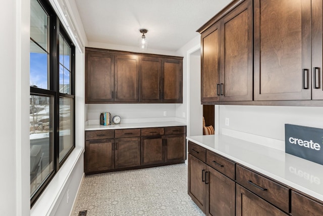 kitchen featuring dark brown cabinetry