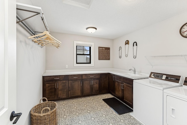 laundry area with cabinets, washer and dryer, and sink